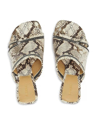 Pair of snake print sandals on a white background