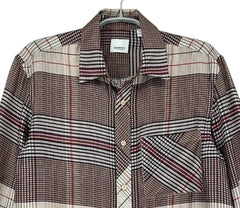 A long-sleeve plaid button-up shirt with a mix of brown, beige, and red checkered patterns, hanging on a gray hanger against a white background.