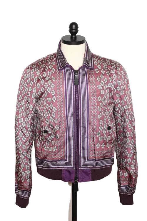A pink and purple patterned bomber jacket displayed on a black dress form mannequin against a white background.