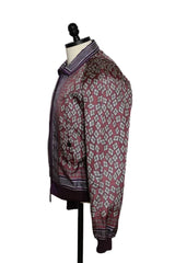 A patterned button-up shirt jacket displayed on a black dress form mannequin against a plain white wall.