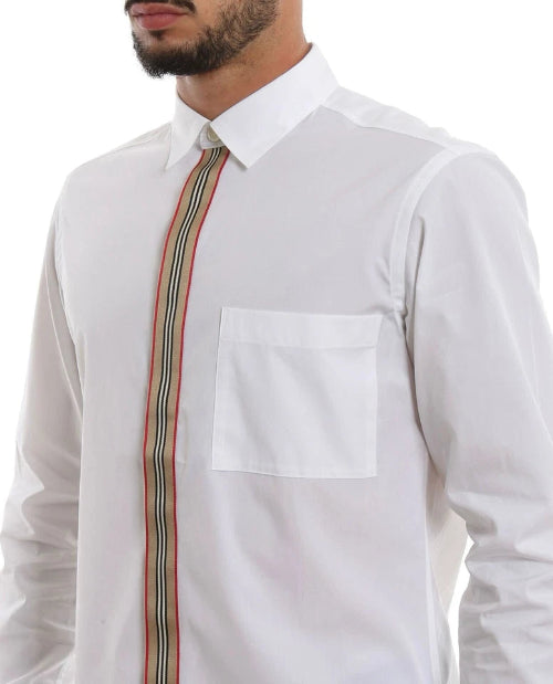 A close-up of a man wearing a white long-sleeve dress shirt with a brown patterned tie, cropped from the lower face to the waist.