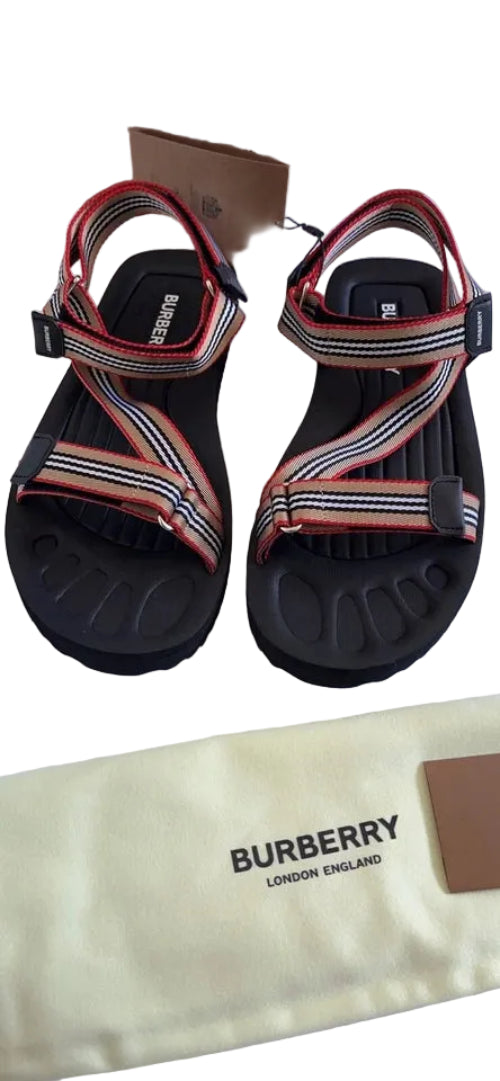 Pair of sandals with Burberry branding on a white surface.