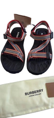 Pair of sandals with Burberry branding on a white surface.