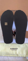 Black sole of a shoe with a Burberry logo on a beige background