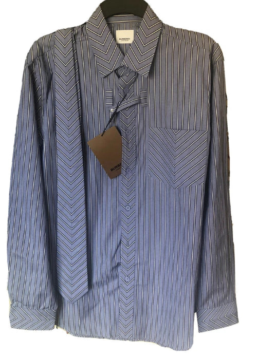 A men's long-sleeve button-down shirt with a blue and white striped chevron pattern, featuring a chest pocket and a matching necktie, shown on a black hanger with a brown paper tag.