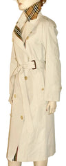 A beige trench coat displayed on a mannequin, featuring a matching beige plaid neck scarf with brown and black stripes.