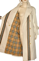 A beige trench coat displayed on a mannequin, shown open to reveal a classic tartan plaid lining in tan, beige, black, and white.