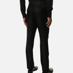 A person wearing black slim-fit trousers, shown from the waist down against a plain white background.