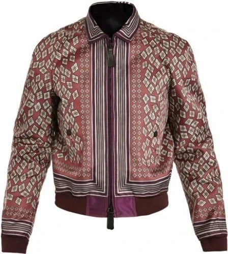 A patterned bomber jacket with a dusty rose base, featuring geometric diamond motifs and vertical stripes in cream, brown, and purple, with a dark purple ribbed hem and cuffs.