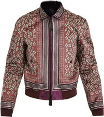 A patterned bomber jacket with a dusty rose base, featuring geometric diamond motifs and vertical stripes in cream, brown, and purple, with a dark purple ribbed hem and cuffs.
