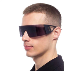 Person wearing futuristic sunglasses with a dark background