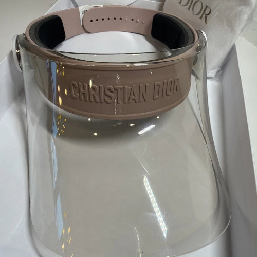 Clear glass bottle with a brown leather strap and label on a white background