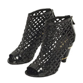 Black open-toe shoes with cut-out design on a white background