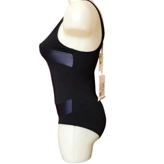 Black dress on a mannequin with a red textured background