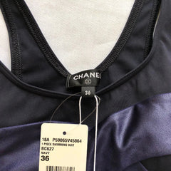 Navy swimsuit with Chanel tag on a white background