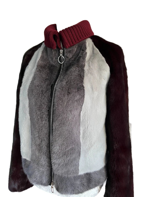 Mannequin wearing a fur jacket with a maroon collar and gray body.