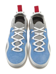 A pair of light blue canvas sneakers with white laces and red accents on the tongue and heel, shown against a plain white background.