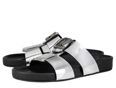 Silver and black sandals with metallic buckle on a white background