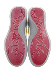 A pair of athletic shoes shown from the bottom, featuring a vibrant pink and red gradient sole with white script lettering and a white midsole.