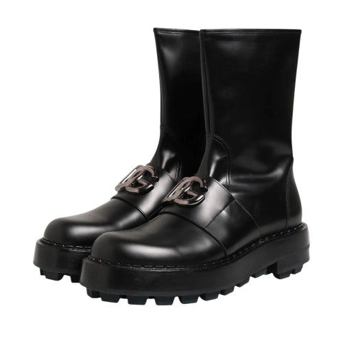 Black leather lace-up boots with chunky lug soles and decorative metal hardware, shown against a plain white background.