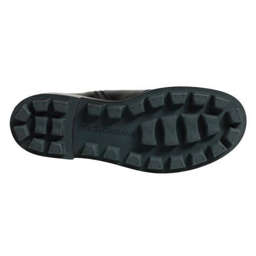 The treaded black rubber outsole of a Dolce & Gabbana boot, shown from a top-down view against a plain white background.