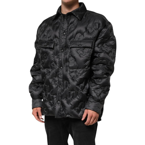 Black quilted jacket worn by a person on a white background