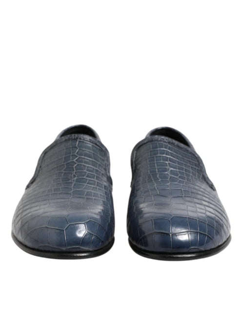 Pair of blue textured loafers on a white background