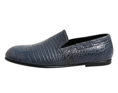 Blue crocodile-textured loafer shoe on a white background