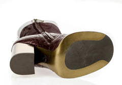 A close-up of a brown leather boot or shoe showing the heel and outsole against a white background.