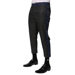 Black pants worn by a person on a white background
