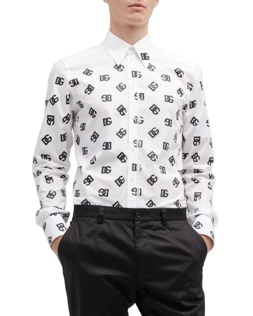Person wearing a white shirt with black pattern and black pants on a white background