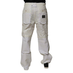 A pair of off-white canvas work pants with darker beige reinforced knee patches, shown from the back on a model against a white background.