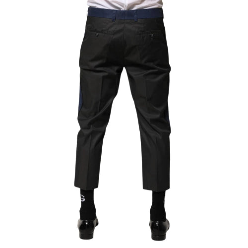 Black pants worn by a person on a white background