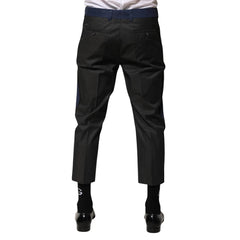 Black pants worn by a person on a white background