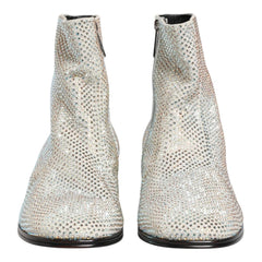 A pair of women's ankle boots with a textured, snakeskin-like pattern in light beige and white, shown from the front against a plain white background.
