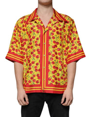 Person wearing a vibrant yellow shirt with red cherry pattern on a white background