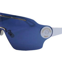Blue sunglasses with gold accents on a light blue background
