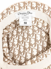 Christian Dior fabric swatch with logo pattern on a beige background