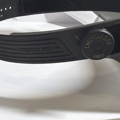 Close-up of a black Christian Dior sunglasses on a white background
