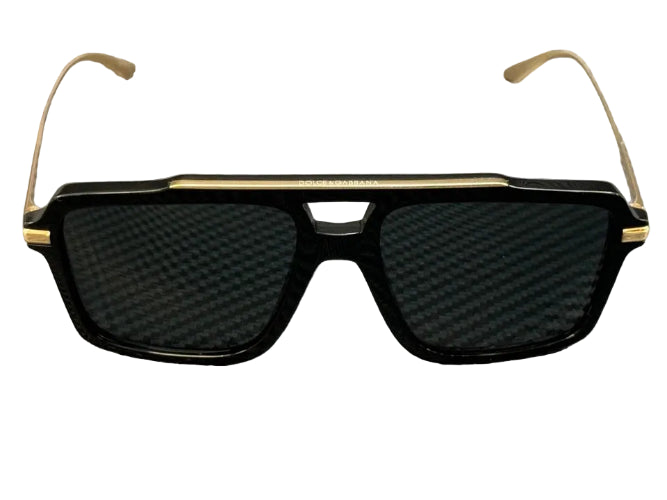 Black sunglasses with gold accents on a textured gray background