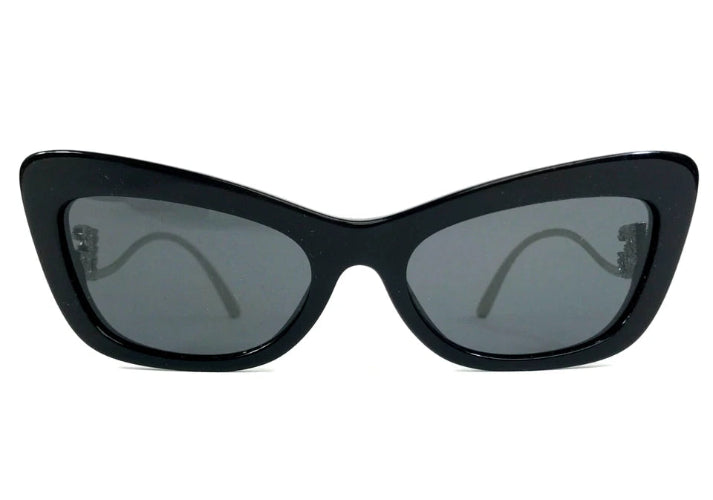 Black cat-eye sunglasses with dark lenses on a white background