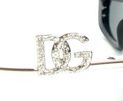 Silver hair clip with 'DG' letters on a white background