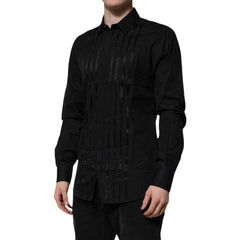 Black long-sleeve shirt with intricate design on a white background