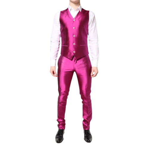 Person wearing a bright pink suit with a white shirt on a white background