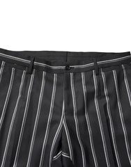Black pinstripe pants with a button on a white background