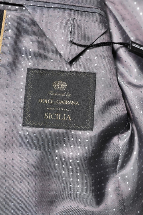 Dolce & Gabbana branded garment with a label on a gray textured fabric background