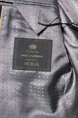 Dolce & Gabbana branded garment with a label on a gray textured fabric background
