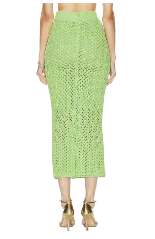 Green crochet skirt worn by a person on a white background