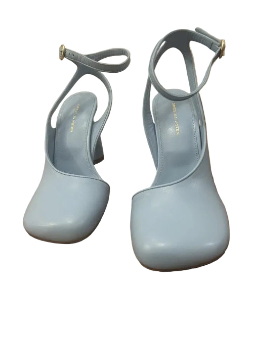 Pair of light blue high-heeled shoes on a wooden floor.