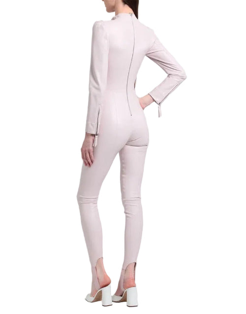 Person wearing a light pink suit on a white background